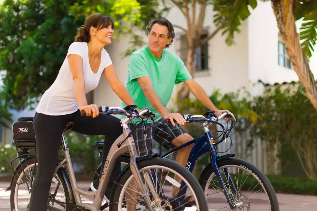A man and woman cycling their bikes 